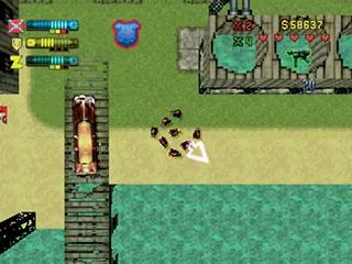 Top-down GTA 2 screenshot showing the player near an industrial area, with gang reputation indicators on screen